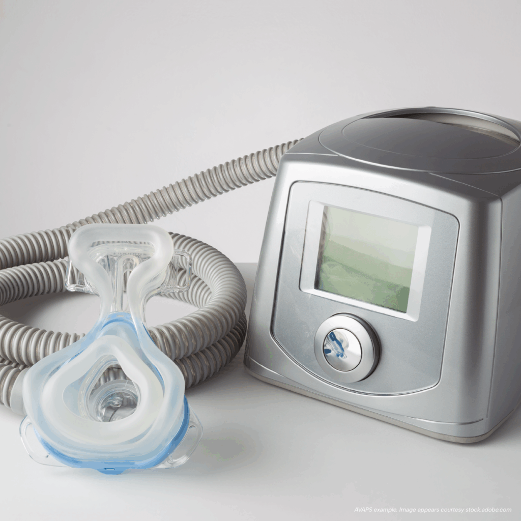 AVAPS ventilator with display screen, tubing, and a full-face mask on a white surface.